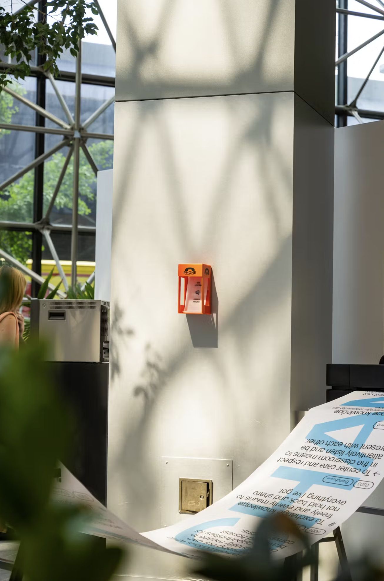 orange miniature phone booth hanging on wall